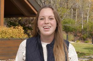 student in front of Founder's Hall
